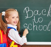 Schoolchild writting on blackboard.