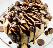 A chocolate and peanut butter flavored cake covered with peanut butter glaze and lots of chopped peanut butter cups.