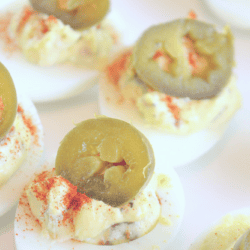 Jalapeño Deviled Eggs Recipe When you think of a potluck dinner, what do you think of? For me, a good potluck HAS to include deviled eggs. It's simply a must-have staple to any family and friend gathering. And while you COULD make deviled eggs the traditional way with mayo, relish, and hard-boiled eggs, why not add a little pizzazz to it? Have your potluck mates raise their eyebrows in approval. Have your potluck mates raise their eyebrows in approval with Jalapeño Deviled Eggs.