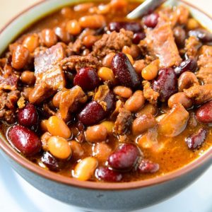 Ground beef, bacon, onions and three varieties of beans, this Crockpot baked beans recipe is the perfect option for a warm, hearty lunch or dinner this fall season.